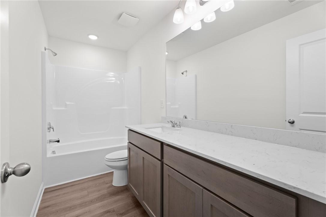 Modern bathroom with vanity, quartz countertop, and tub-shower combo in The Stella D floor plan at Silver Oak, Cusseta.