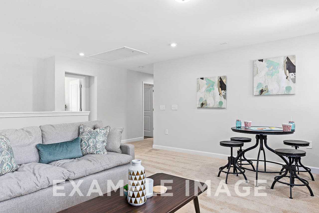 Davidson Homes The Chestnut Plan Loft with couch, tables, and wall art