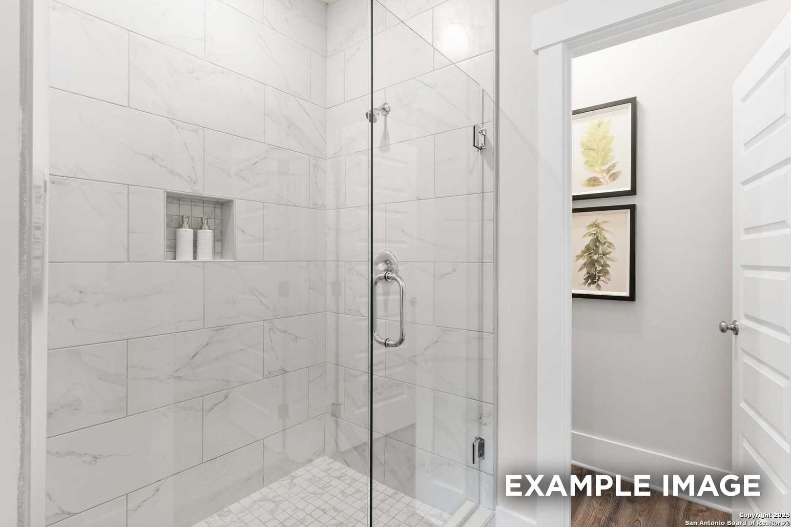 Modern master bathroom with frameless glass shower, subway tile walls, and niche shelf in Davidson Homes The Daphne H, Seguin, Texas