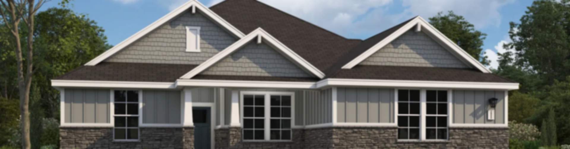 Modern two-story gray home with stone accents, front porch, and lush landscaping in Fayetteville