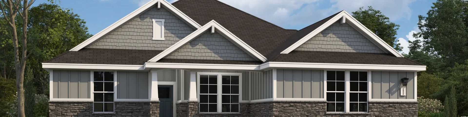 Modern two-story gray home with stone accents, front porch, and lush landscaping in Fayetteville