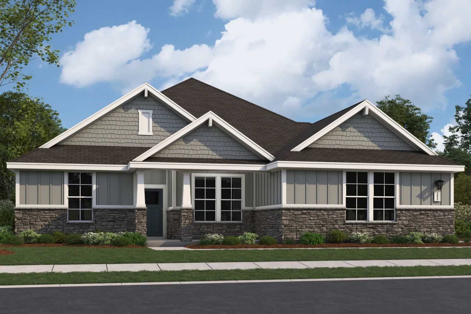 The Arcadia M single-story home elevation with gray siding, stone accents, gabled roof, and 3-car garage by Evermore Homes