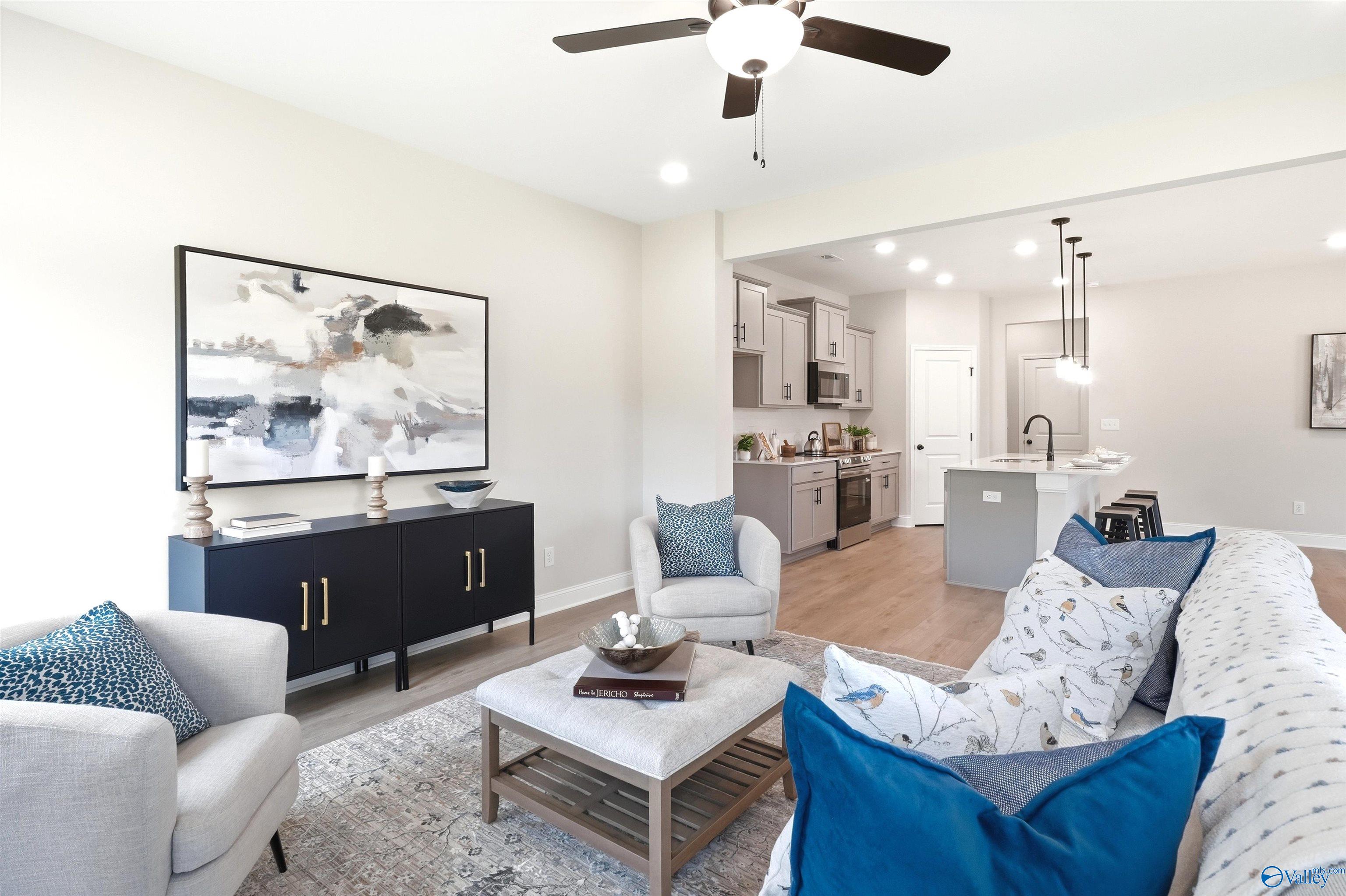 Bright open-concept living room and kitchen with island seating in Davidson Homes The Russell A at Spragins Cove, Huntsville
