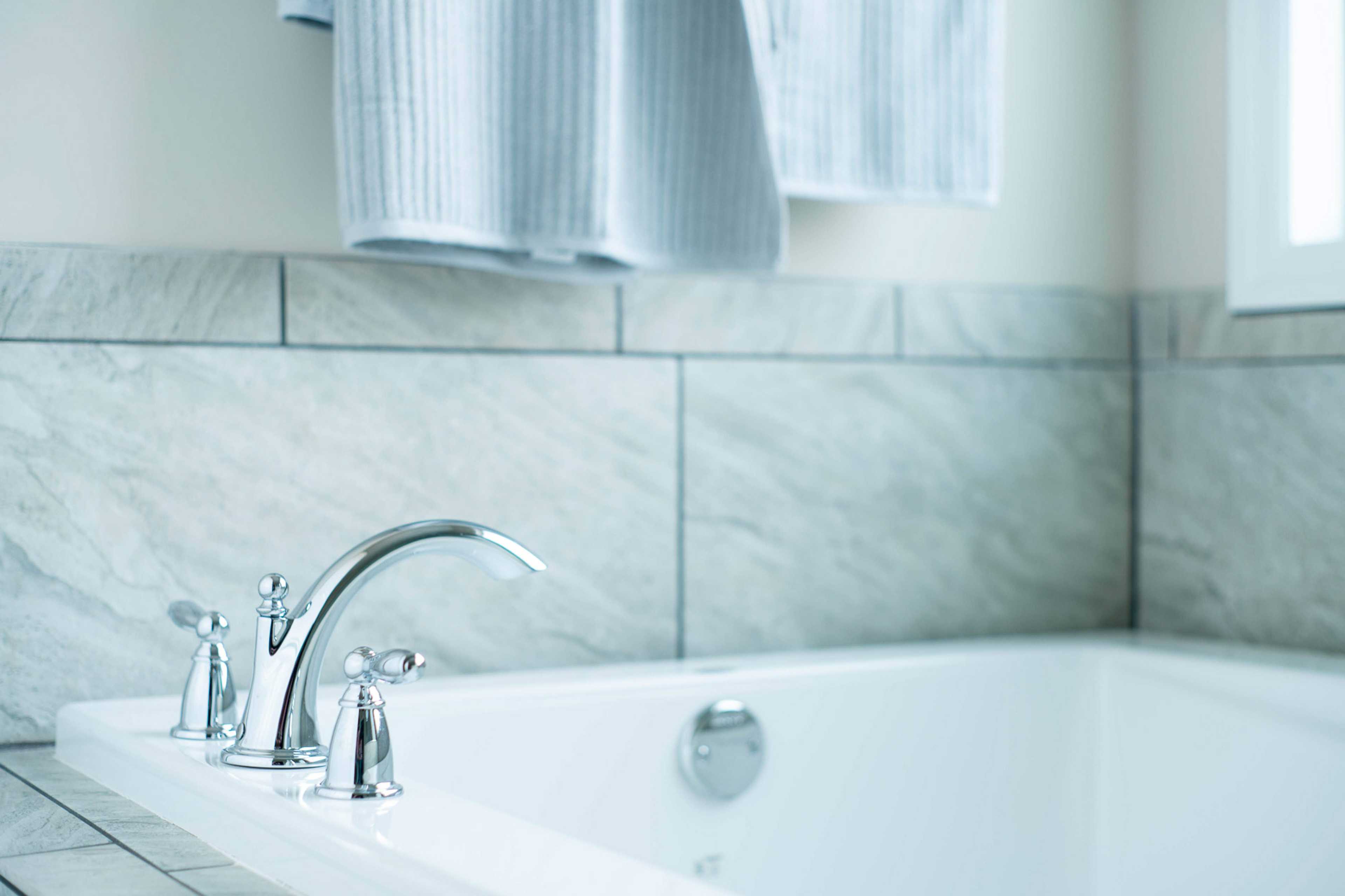 Freestanding bathtub with chrome faucets in luxurious bathroom at The Dairy at Oak Grove, South Huntsville AL by Davidson Homes