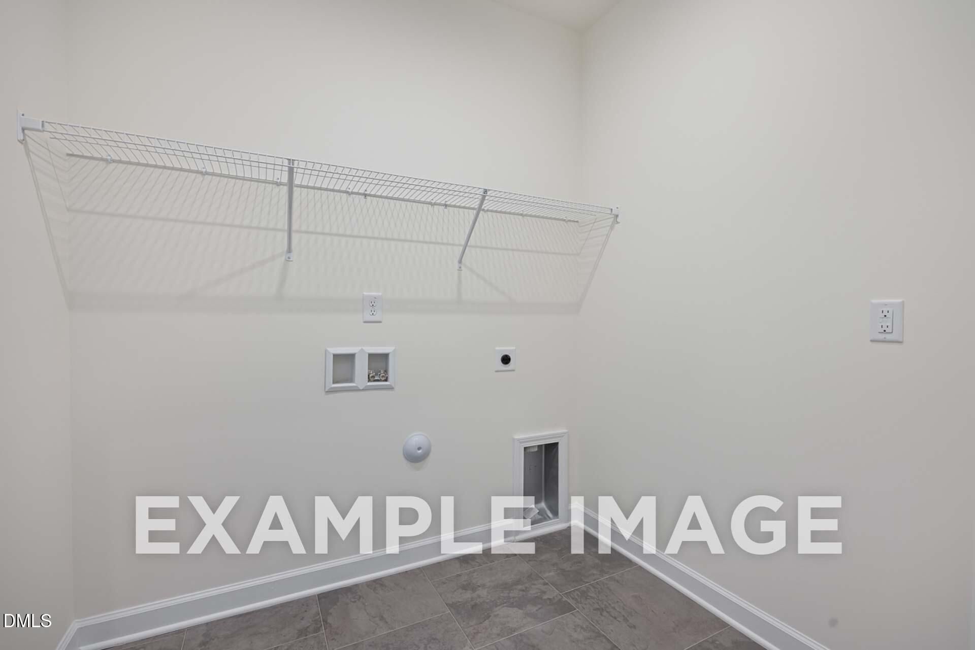 Spacious laundry room with wire shelving, outlets, and pet door in Davidson Homes The Ash B, Zebulon, North Carolina