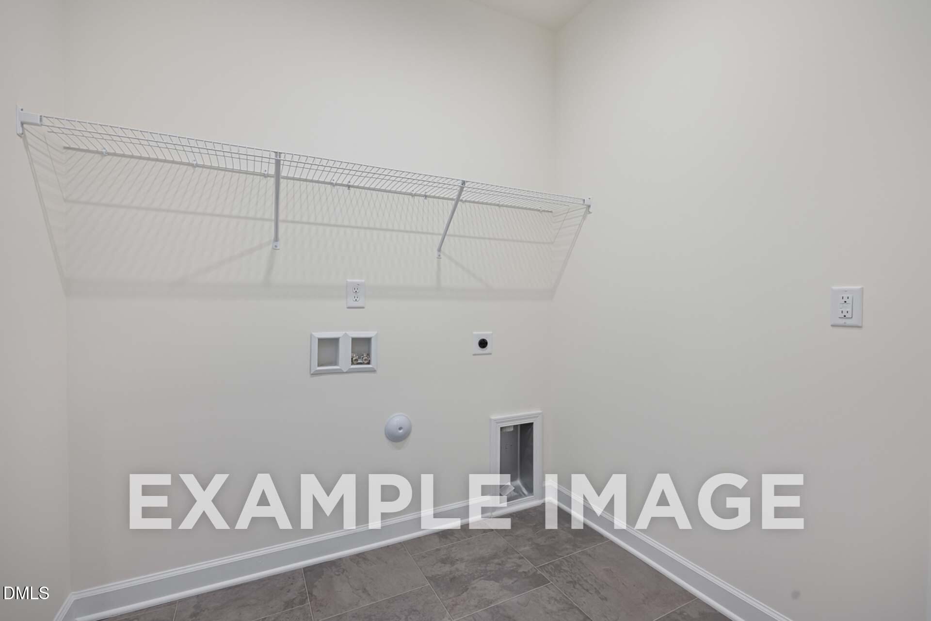 Functional laundry room with wire shelving, utility hookups, pet door in The Ash B 3-bedroom home by Davidson Homes, Zebulon, NC