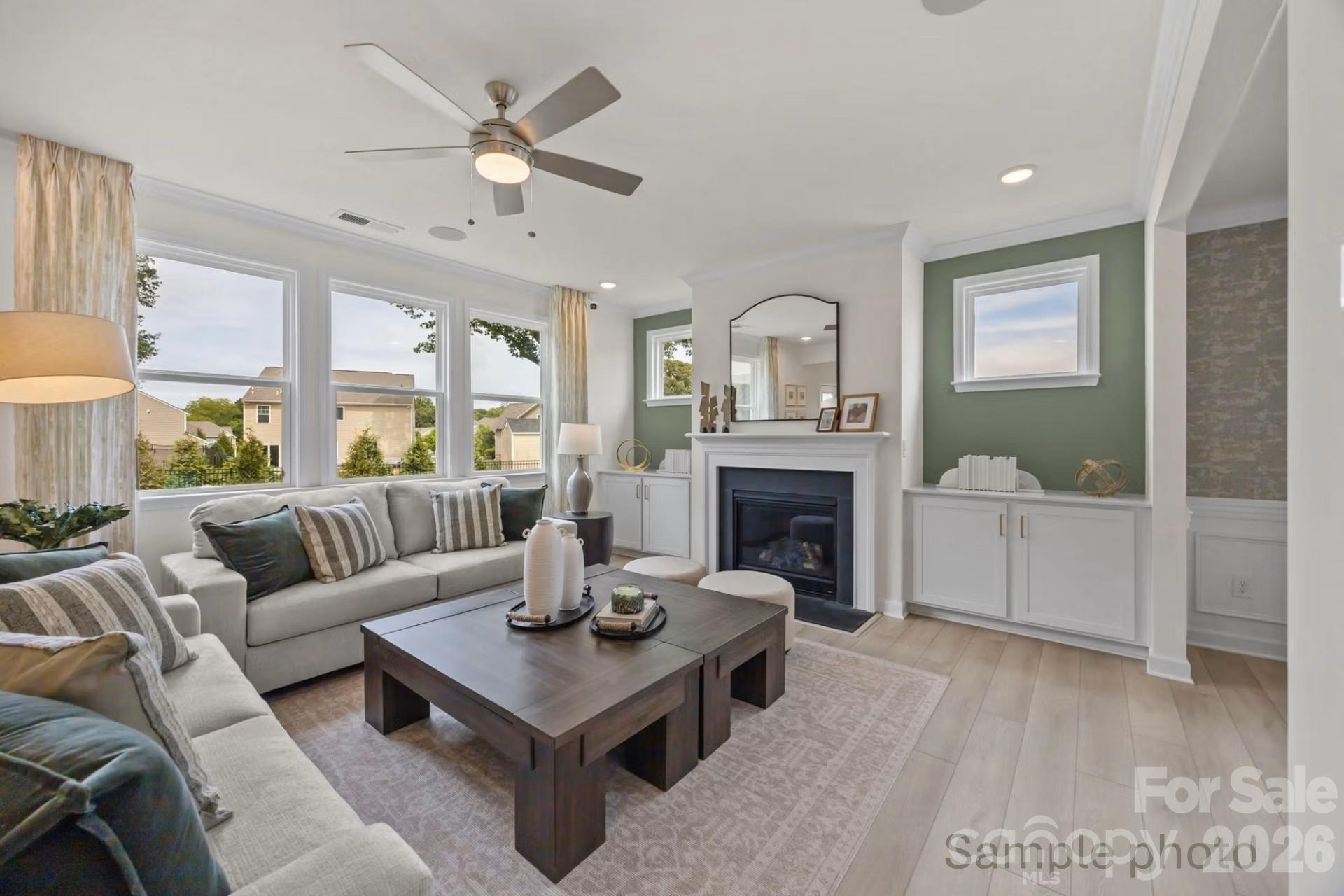 Modern living room with fireplace and built-ins in The Beech B floor plan at Enclave at Belmont, Belmont, North Carolina.