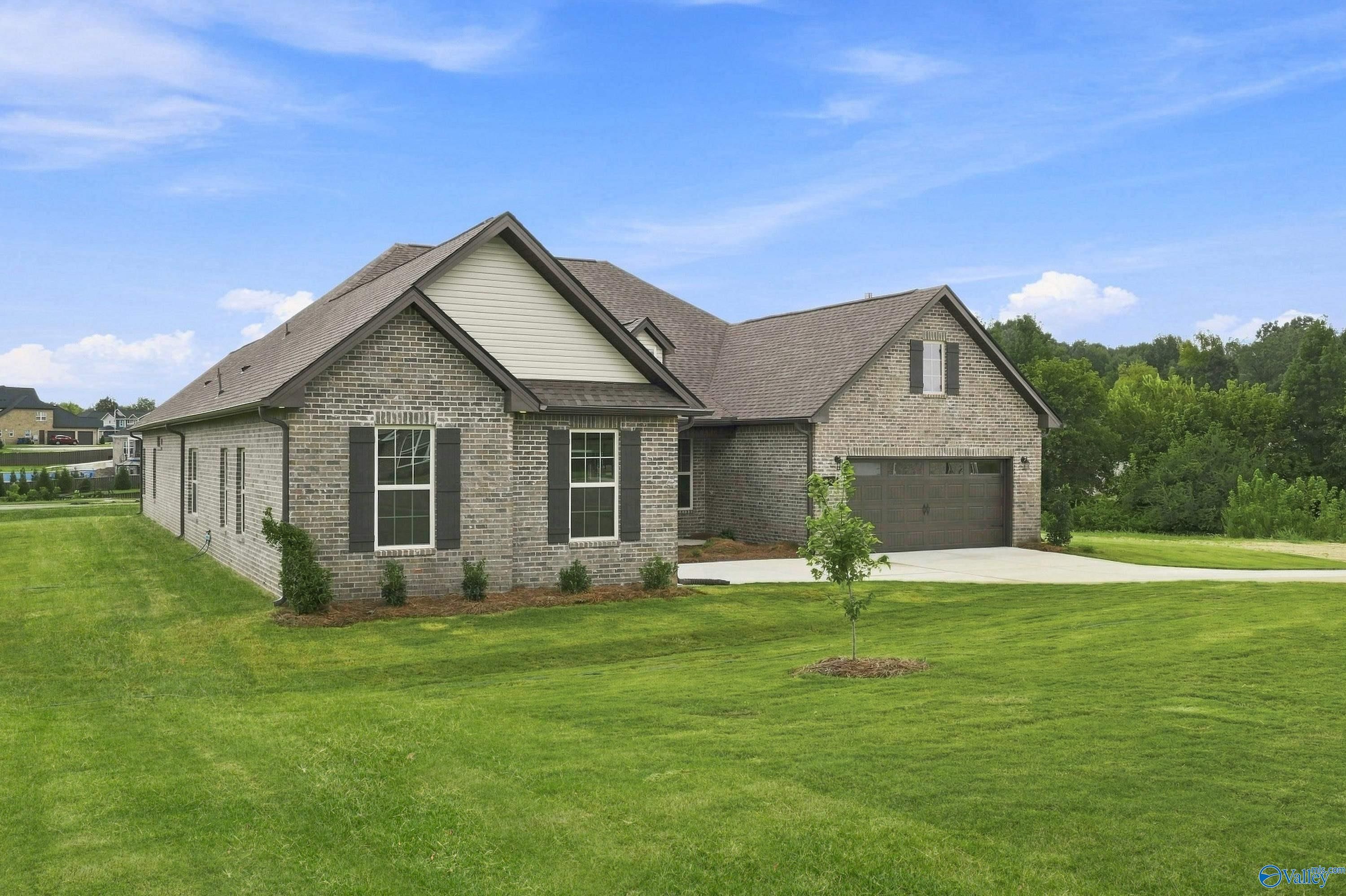 Davidson Homes The Valencia 1-story brick home with 3-car garage in Riverton Preserve, Huntsville, Alabama.