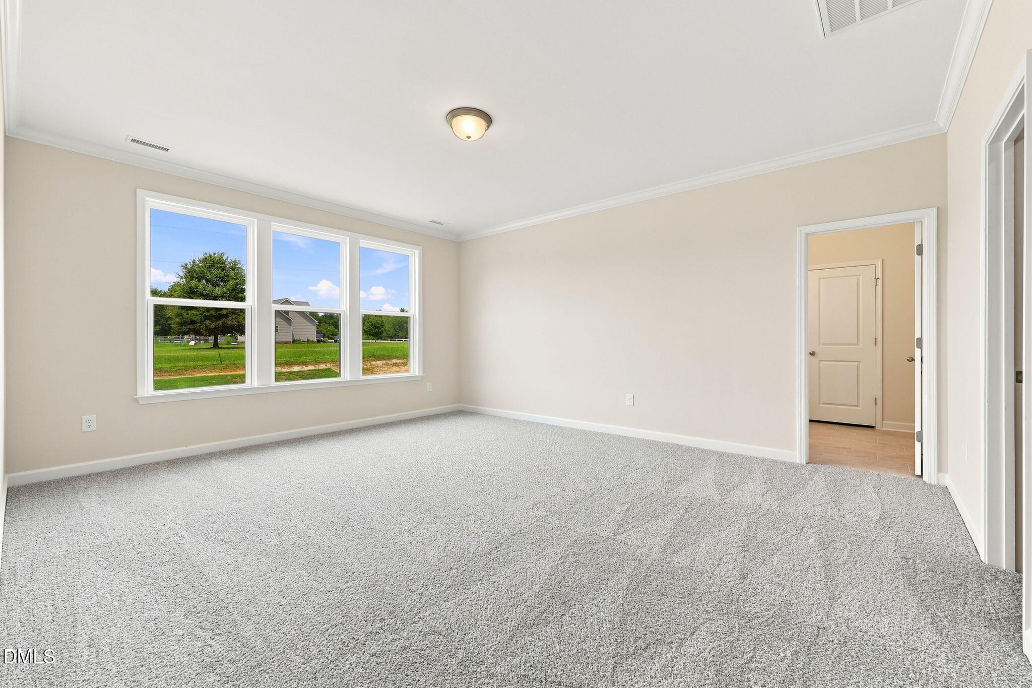 Spacious, carpeted bedroom with natural light in The Magnolia B floor plan at Retreat at North Main, Lillington, NC.