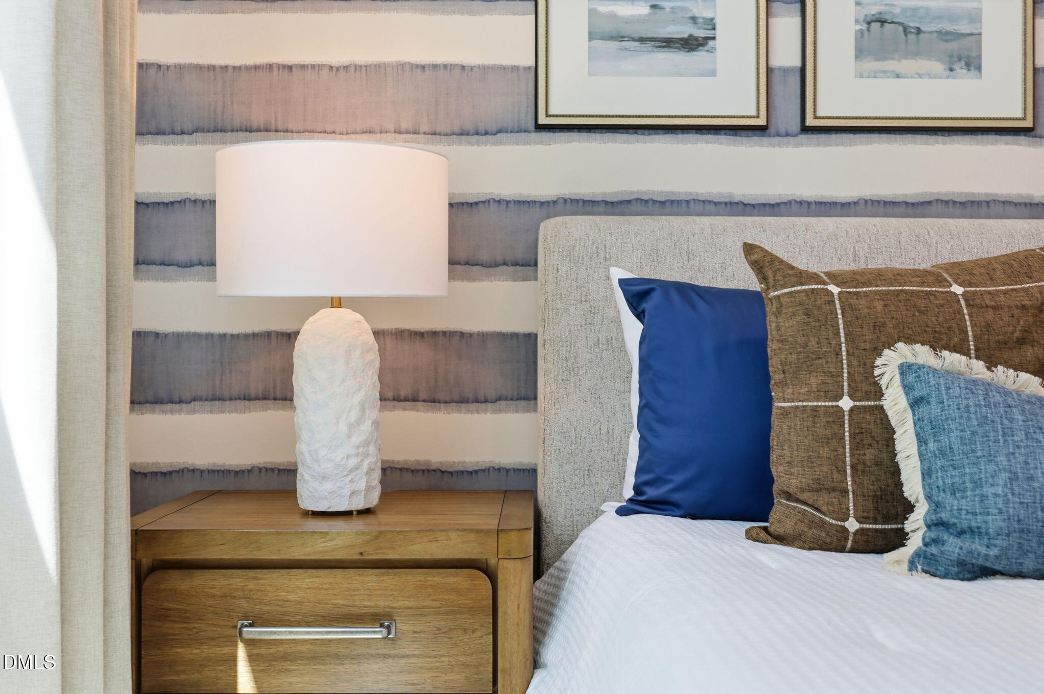 Bedroom detail featuring textured bedside lamp and blue-toned wallpaper in The Aspen B plan at Wendell Ridge, NC.