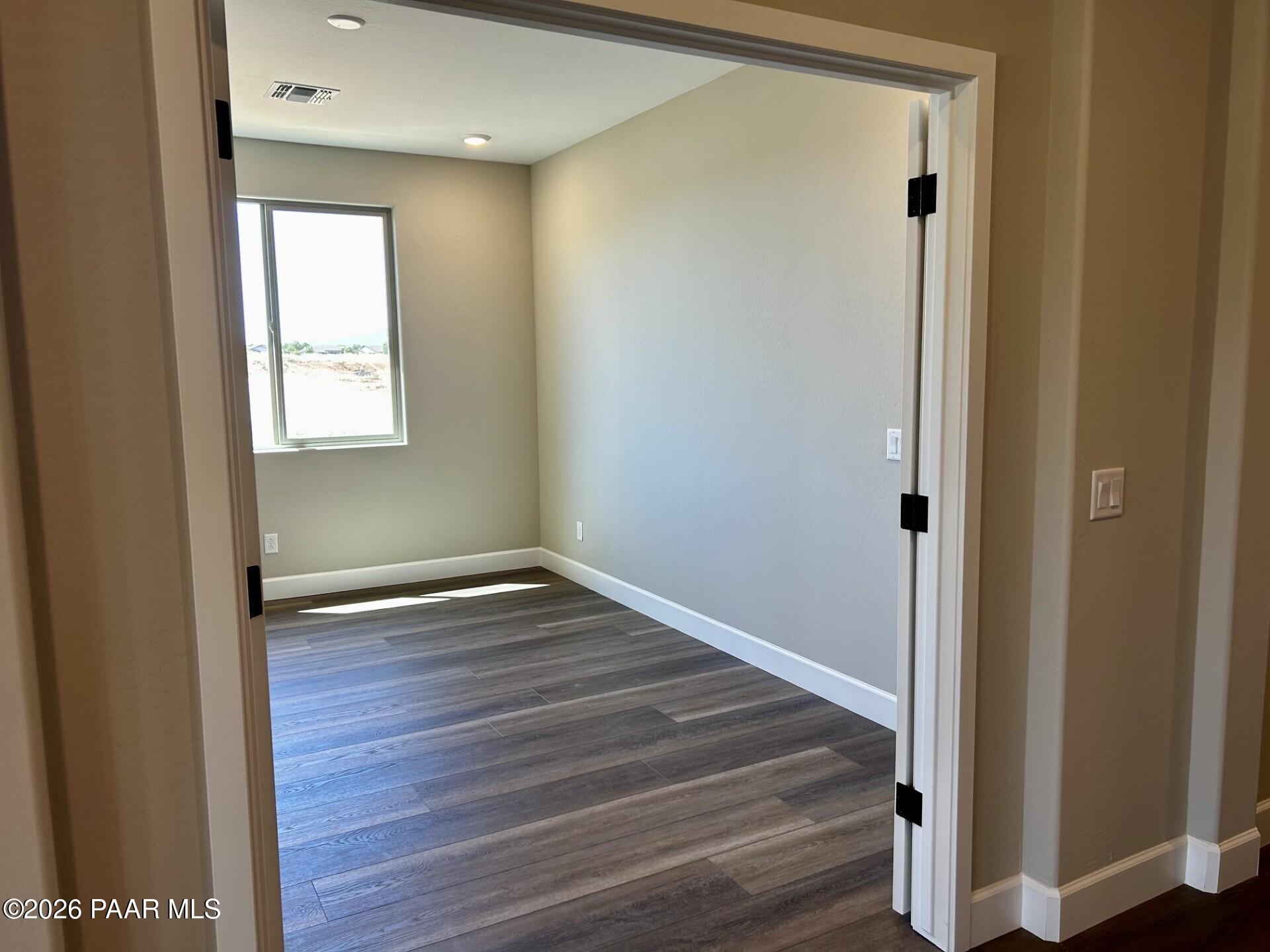 Bright flex room with wood-look flooring in The Harmony C floor plan at North Ridge, Pronghorn Ranch, Prescott Valley.