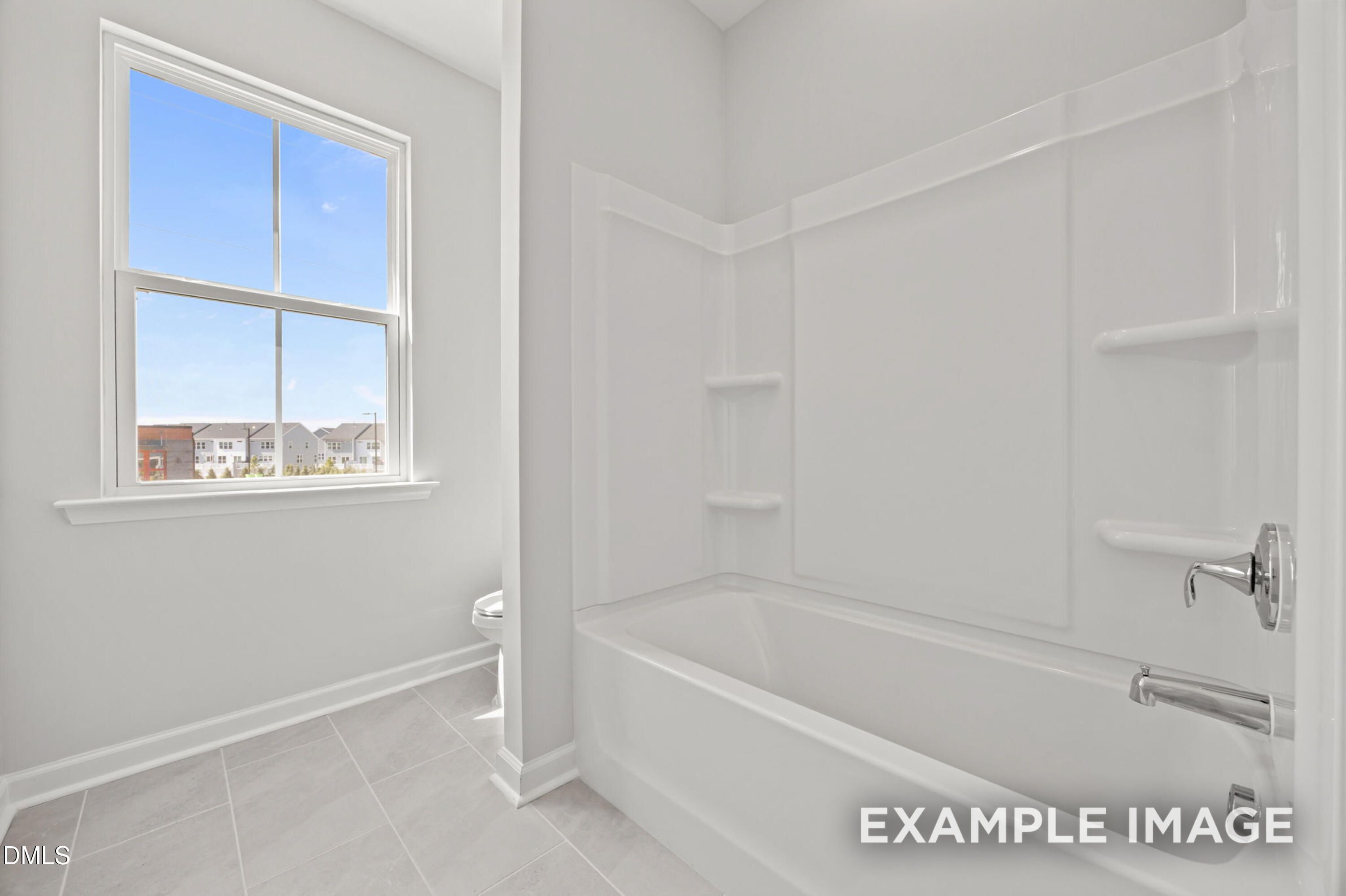 Bright bathroom with white tub-shower combo in The Alexander B floor plan at Forestville Yard, Knightdale, North Carolina.