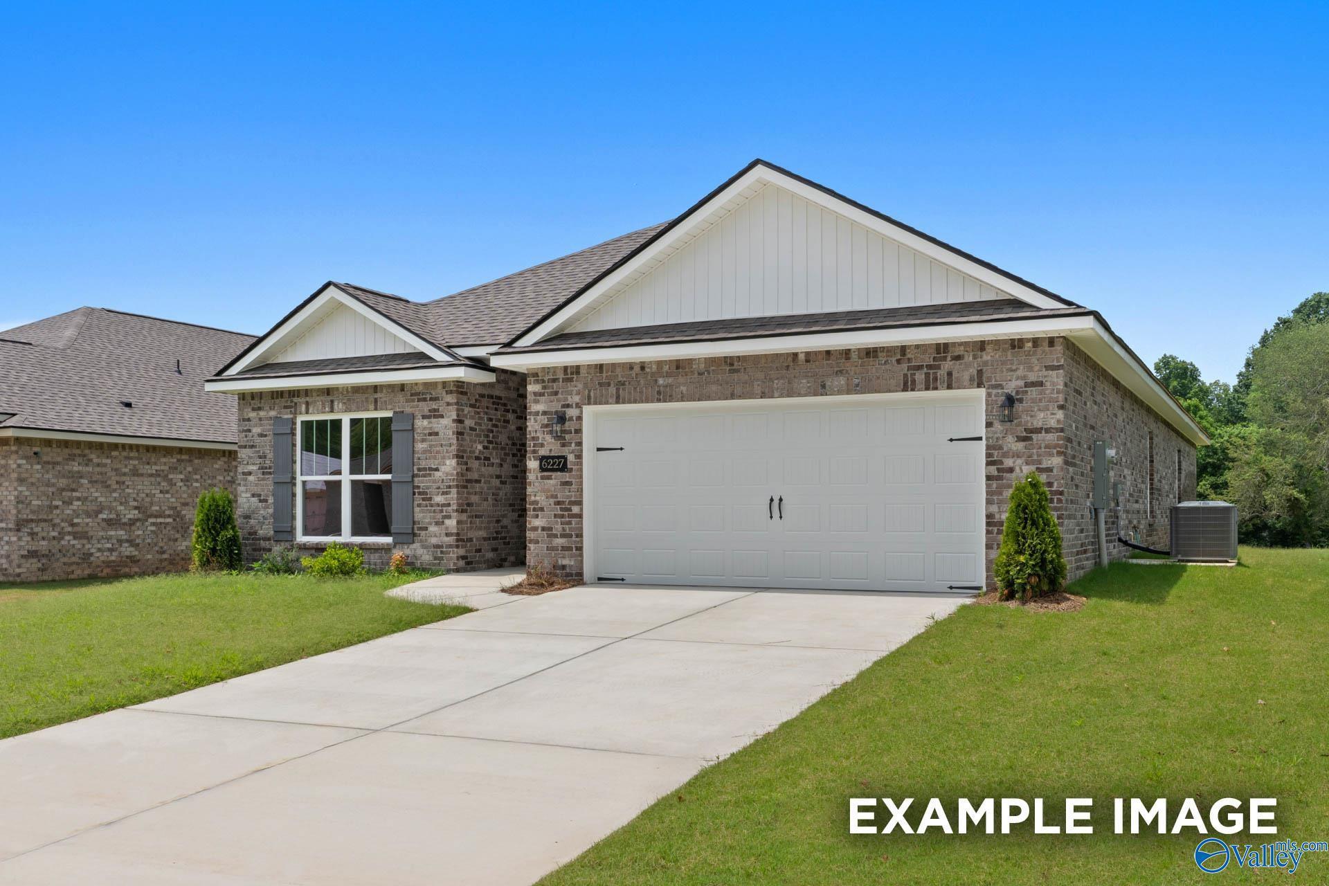 Modern single-story brick home with 2-car garage, driveway, and lush green yard in Lynn Meadows, Meridianville, Alabama - Davidson Homes Everett