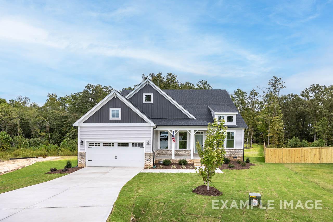 New construction home by Davidson Homes at Retreat at North Main in Lillington, NC with a two-car garage and front porch.