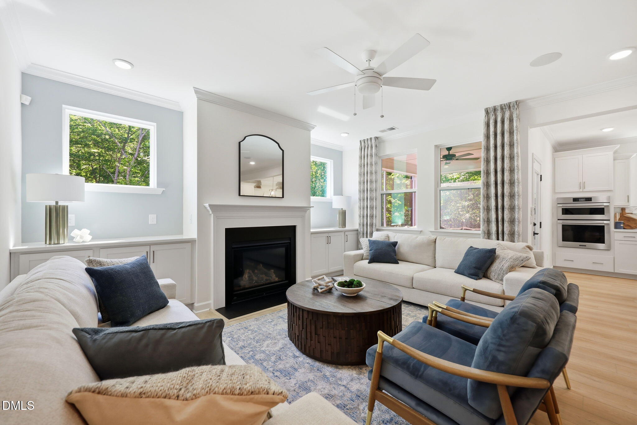 Bright living room with fireplace and open floor plan in The Aspen B home at Wendell Ridge, Wendell, North Carolina.
