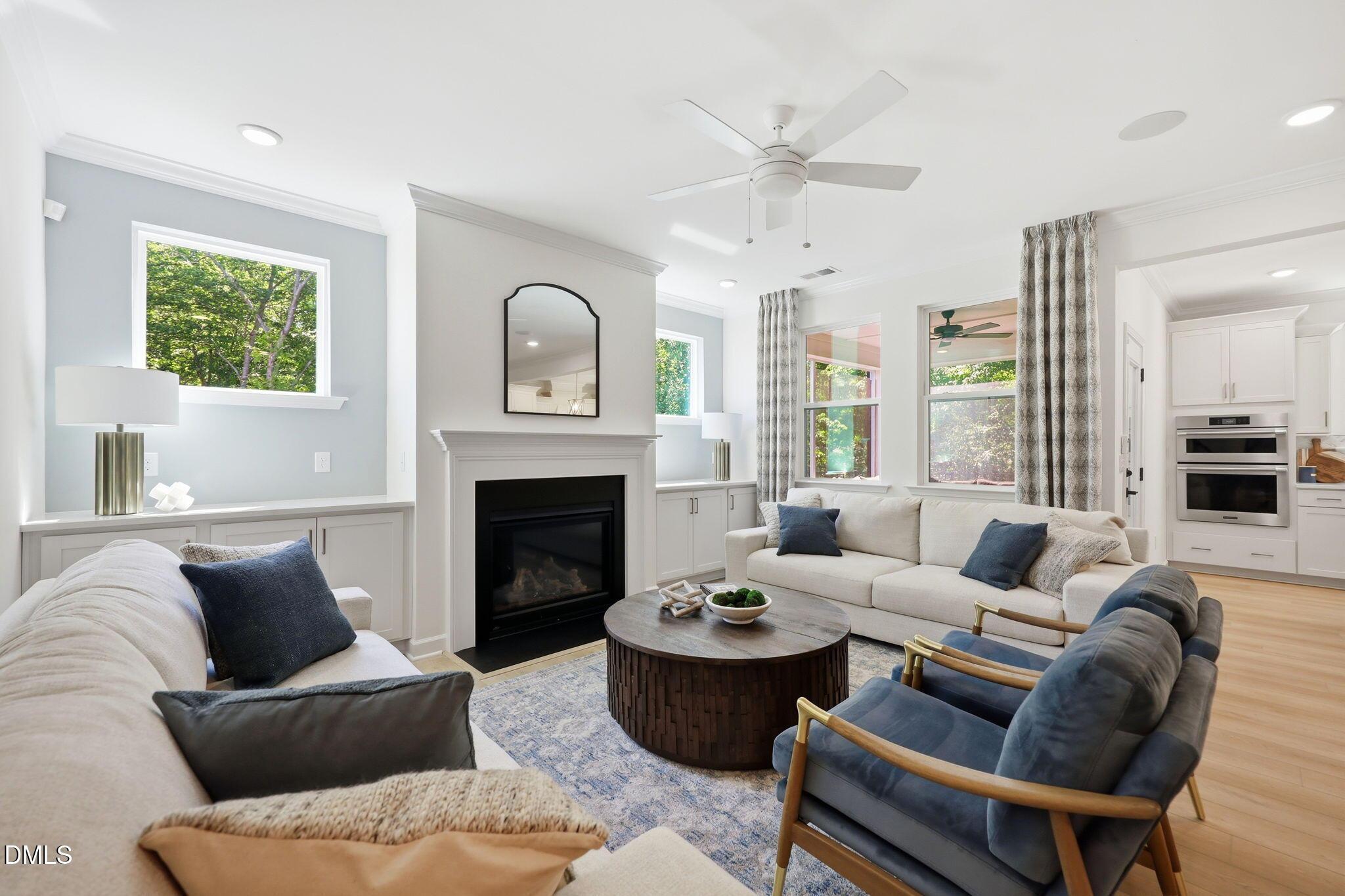 Bright living room with fireplace and open floor plan in The Aspen B home at Wendell Ridge, Wendell, North Carolina.