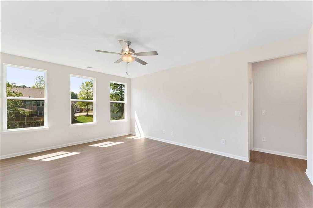 Bright living room with large windows, hardwood floors, and ceiling fan in Davidson Homes The Ash B- Unfinished Basement, Riverwood, Dallas, Georgia