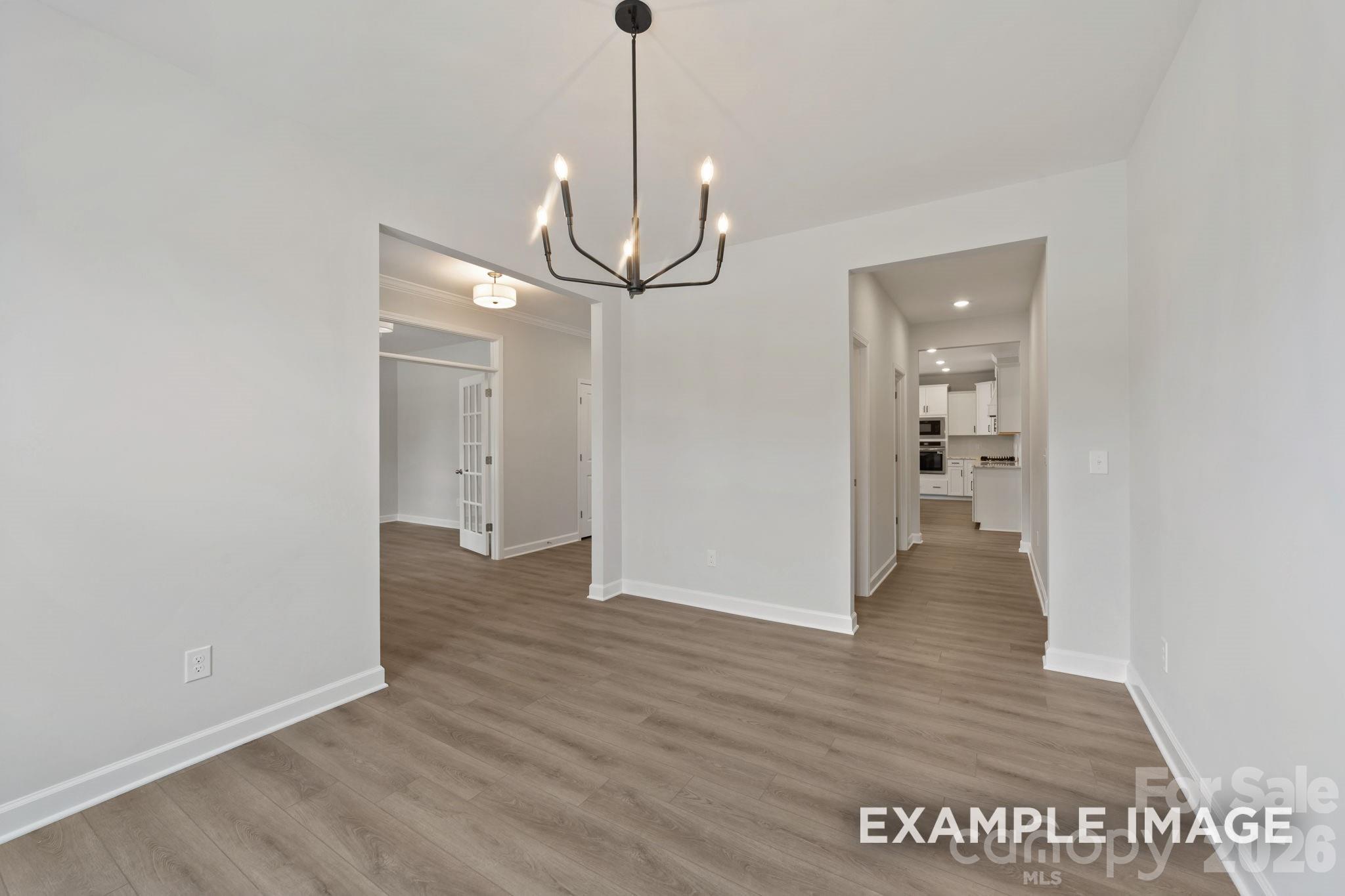 Bright dining area with modern chandelier in The Magnolia B floor plan by Davidson Homes in Windgate, Mooresville, NC.