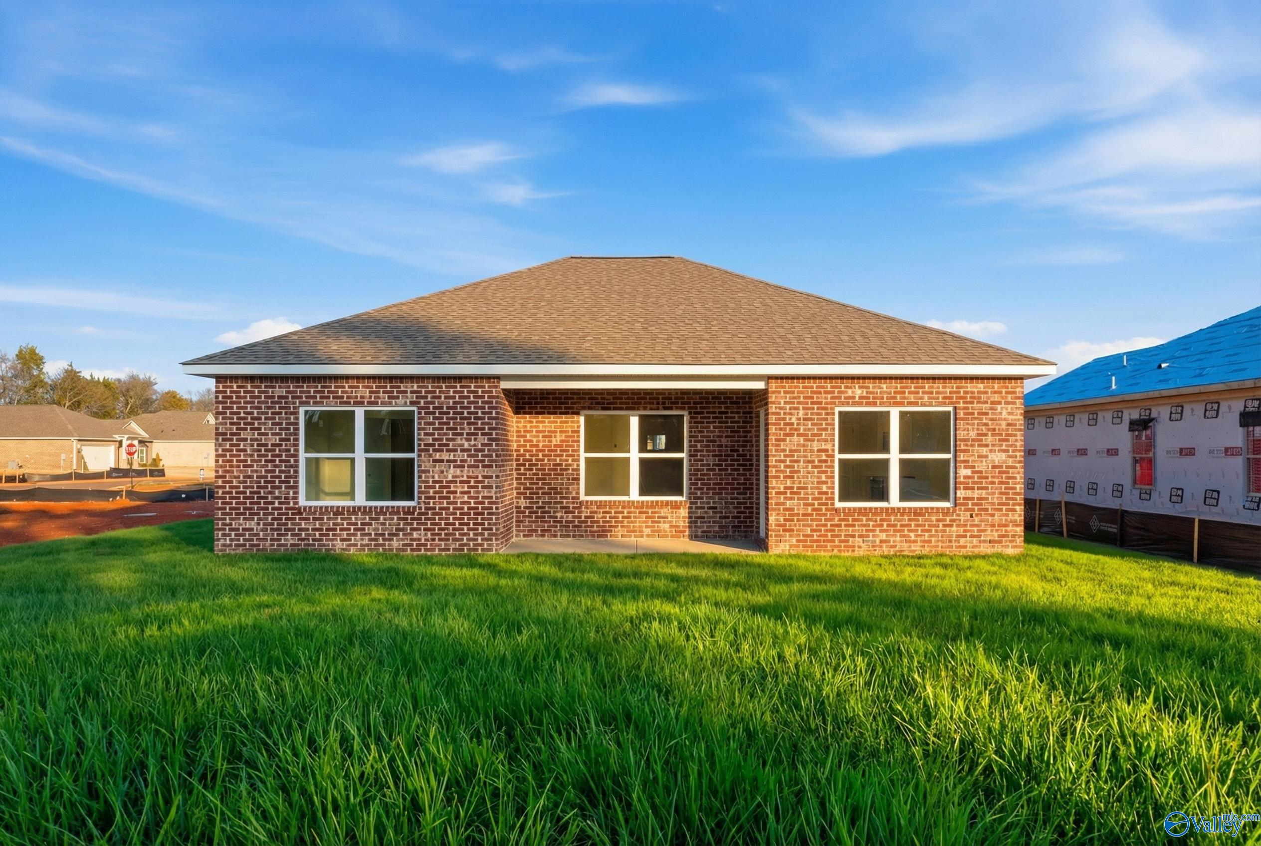 Single-story brick home with gabled roof, covered entry, and lush green lawn in Lynn Meadows, Meridianville, Alabama - Davidson Homes The Asheville C