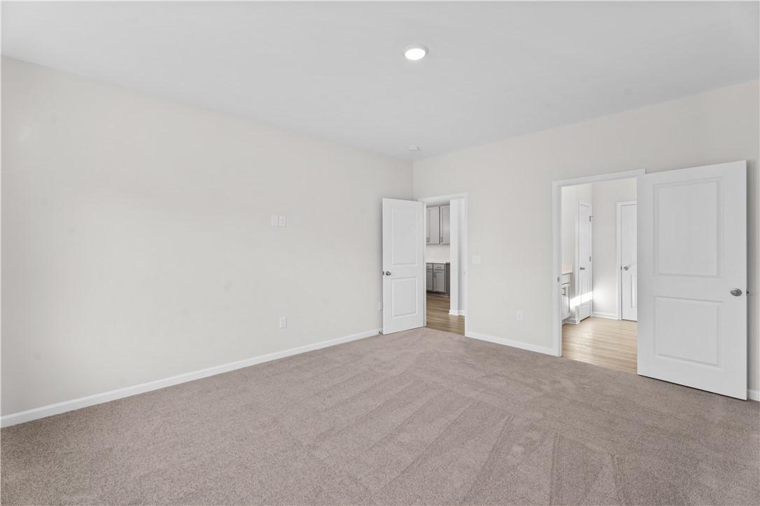 Spacious master bedroom with en-suite bath and closet doors in Davidson Homes The Luna B, Opelika, Alabama