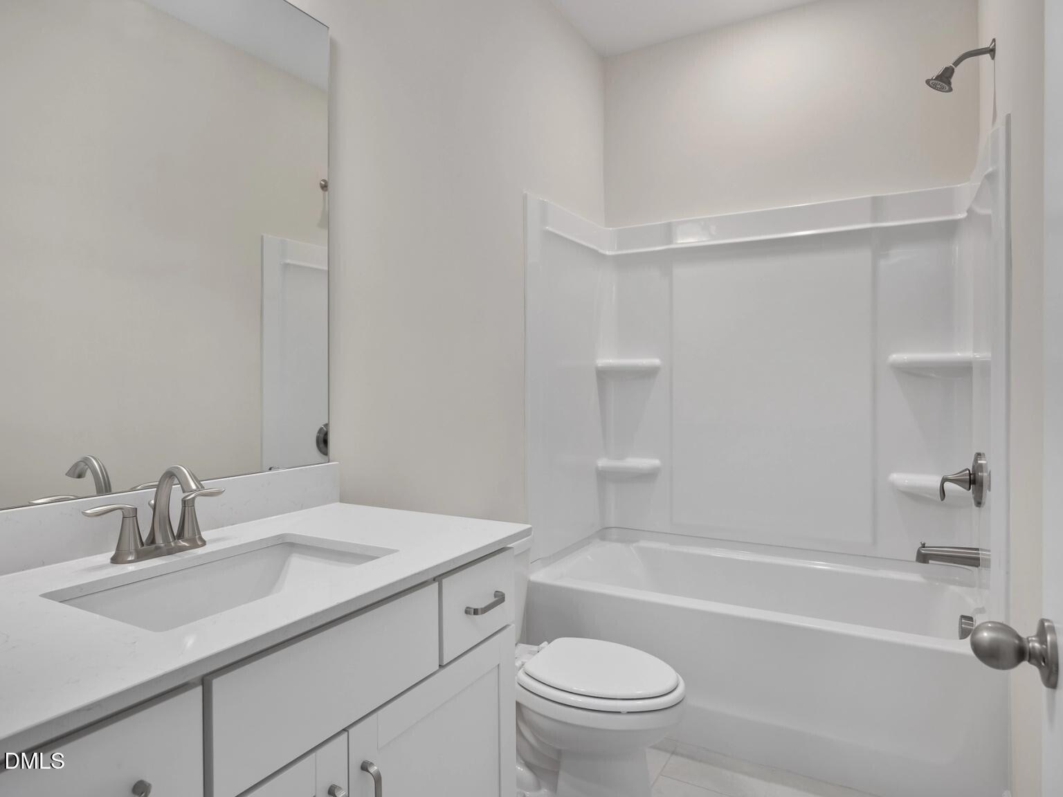 Modern white guest bathroom with tub-shower combo, vanity, and toilet in The Beech B, Davidson Homes, Wake Forest, NC