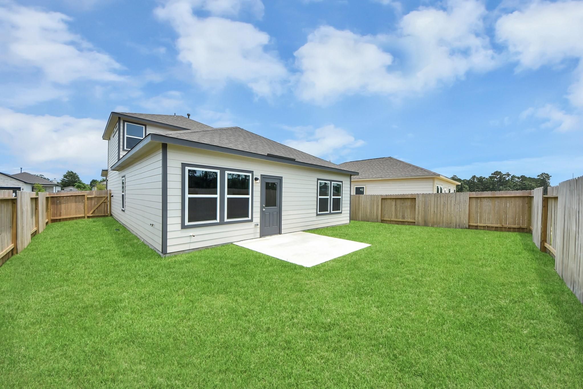 Private backyard with concrete patio at The Blanco E floor plan in The Villages at WestPointe, Dayton, Texas.