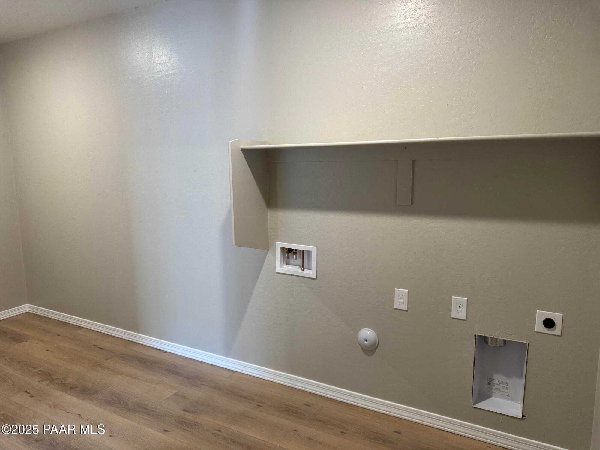 Modern laundry room featuring utility sink, washer-dryer hookups, built-in shelf in Davidson Homes The Sheridan II B, Prescott AZ