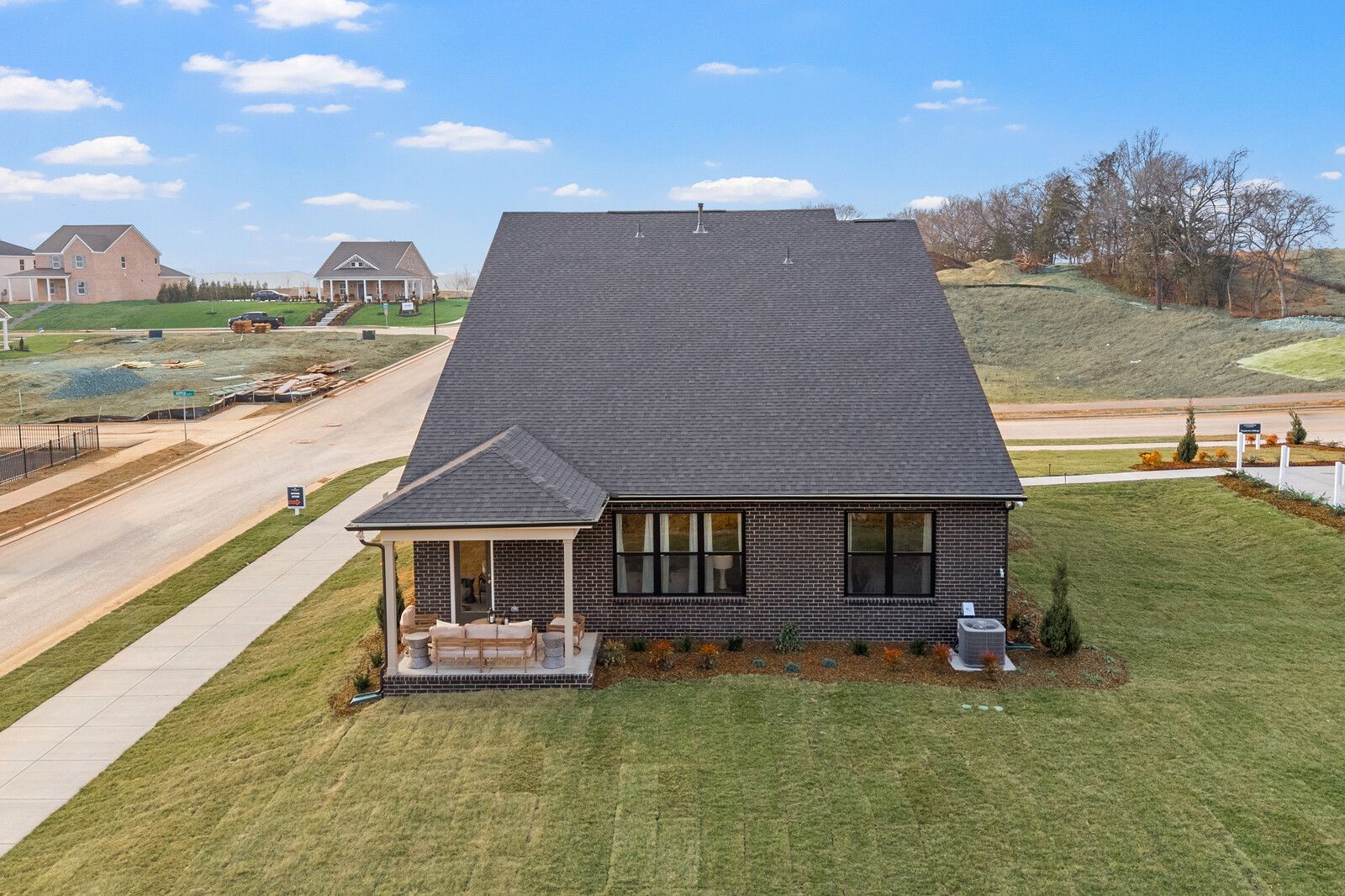 Brick home exterior with covered porch and landscaped yard at Benders Cove in Mt. Juliet TN