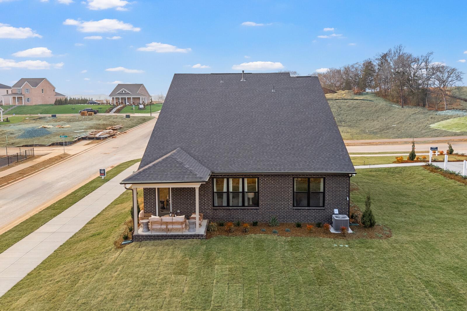 Brick home exterior with covered porch and landscaped yard at Benders Cove in Mt. Juliet TN
