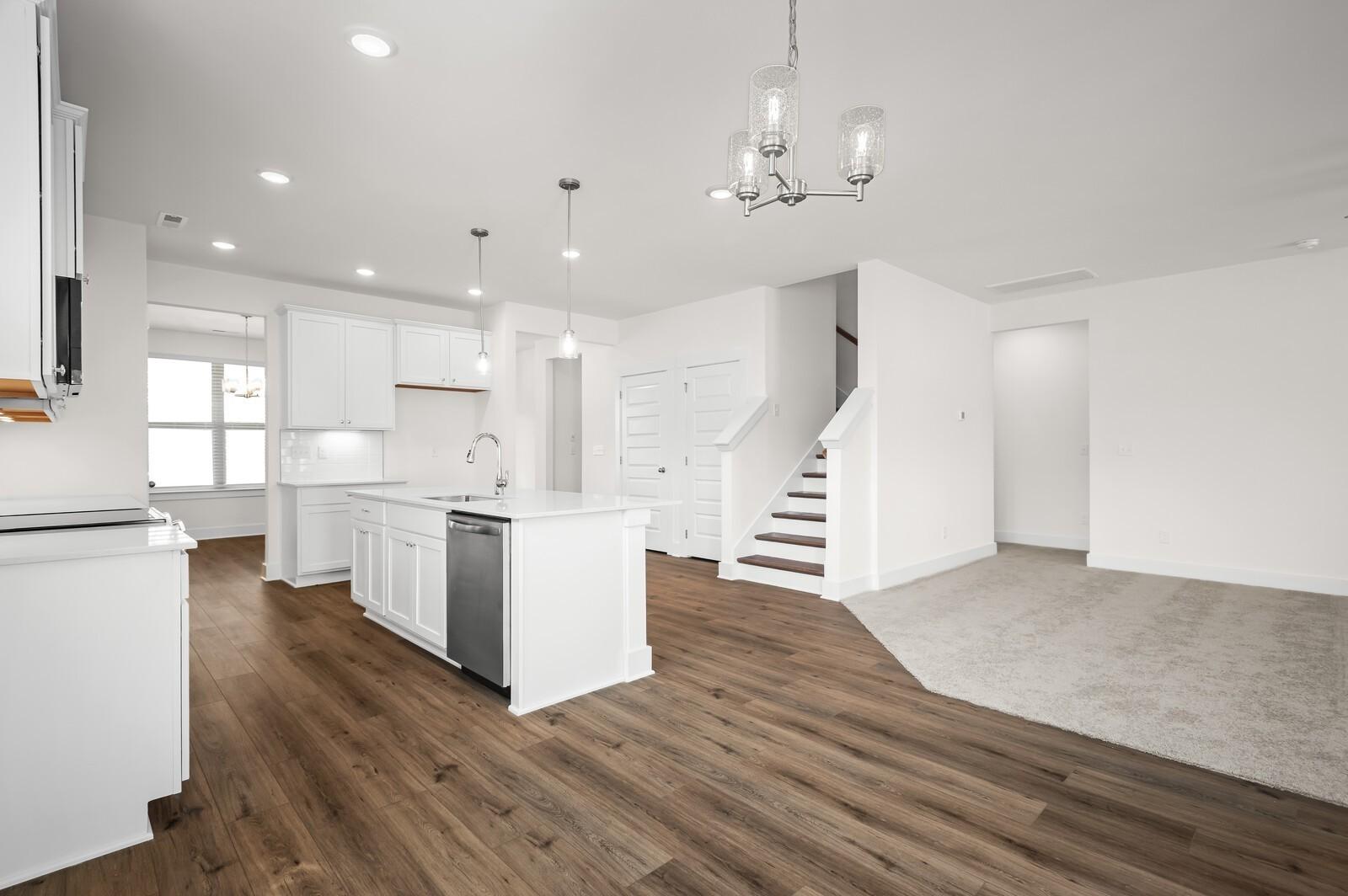 Open-concept kitchen and living area in The Ash A floor plan by Davidson Homes at Woods Crossing in Gallatin, Tennessee.