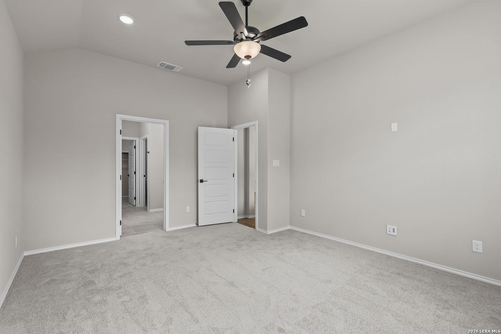 Spacious bedroom with ceiling fan and plush carpet in Davidson Homes The Sequoia C, Royal Crest, San Antonio, Texas