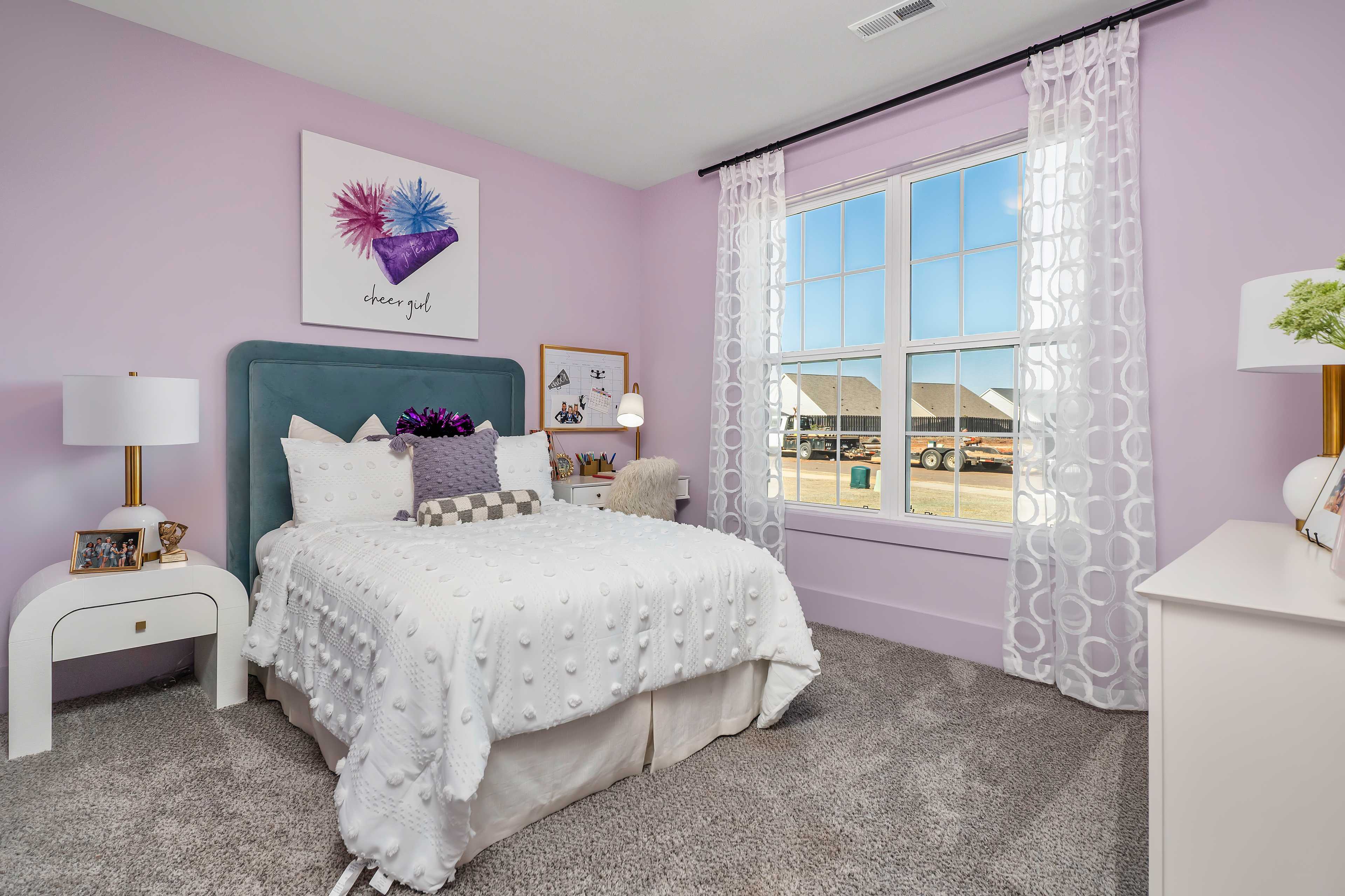 Pink teen bedroom in Barnett's Crossing Madison AL with white tufted bed, nightstands, and neighborhood window view