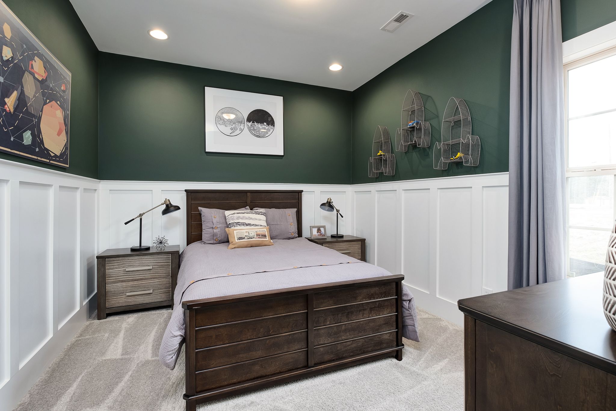 Boy's bedroom at Chimney Creek in Hampton Cove AL with green walls, wooden bed, nightstands, birdcage decor and space art