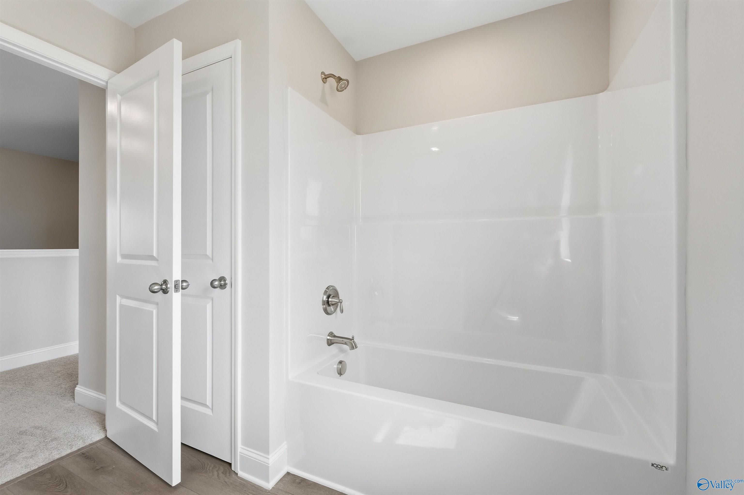 Modern bathroom with white tub-shower combo in The Shelby D floor plan by Davidson Homes, Evergreen Mill, Madison, Alabama