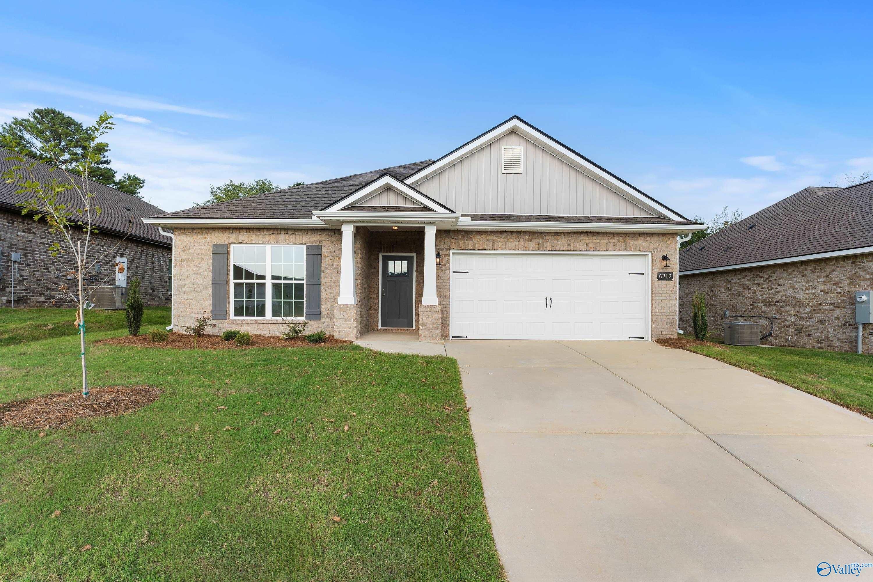 Modern brick single-story home with gabled roof, 2-car garage, and covered porch in Jaguar Hills, Huntsville, Alabama - Davidson Homes The Daphne C