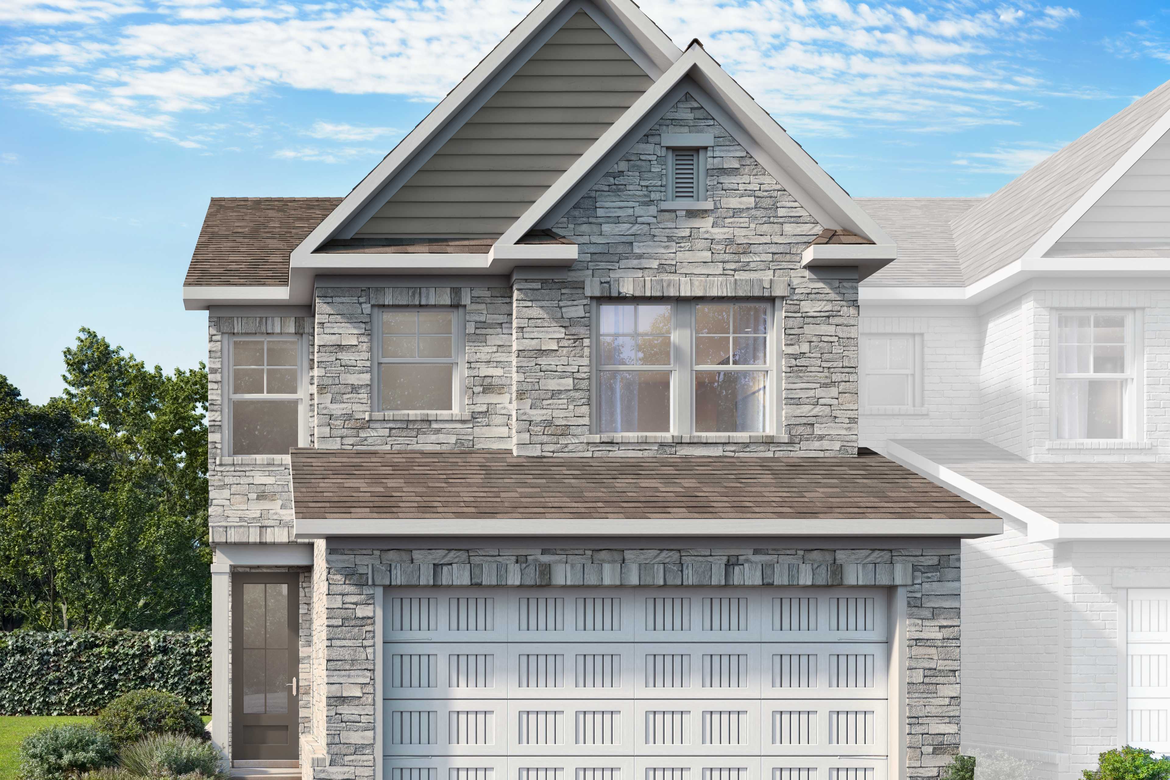 Two-story Cary B LS home elevation with stone siding, gabled roof, two-car garage, and lush landscaping in Winder, GA