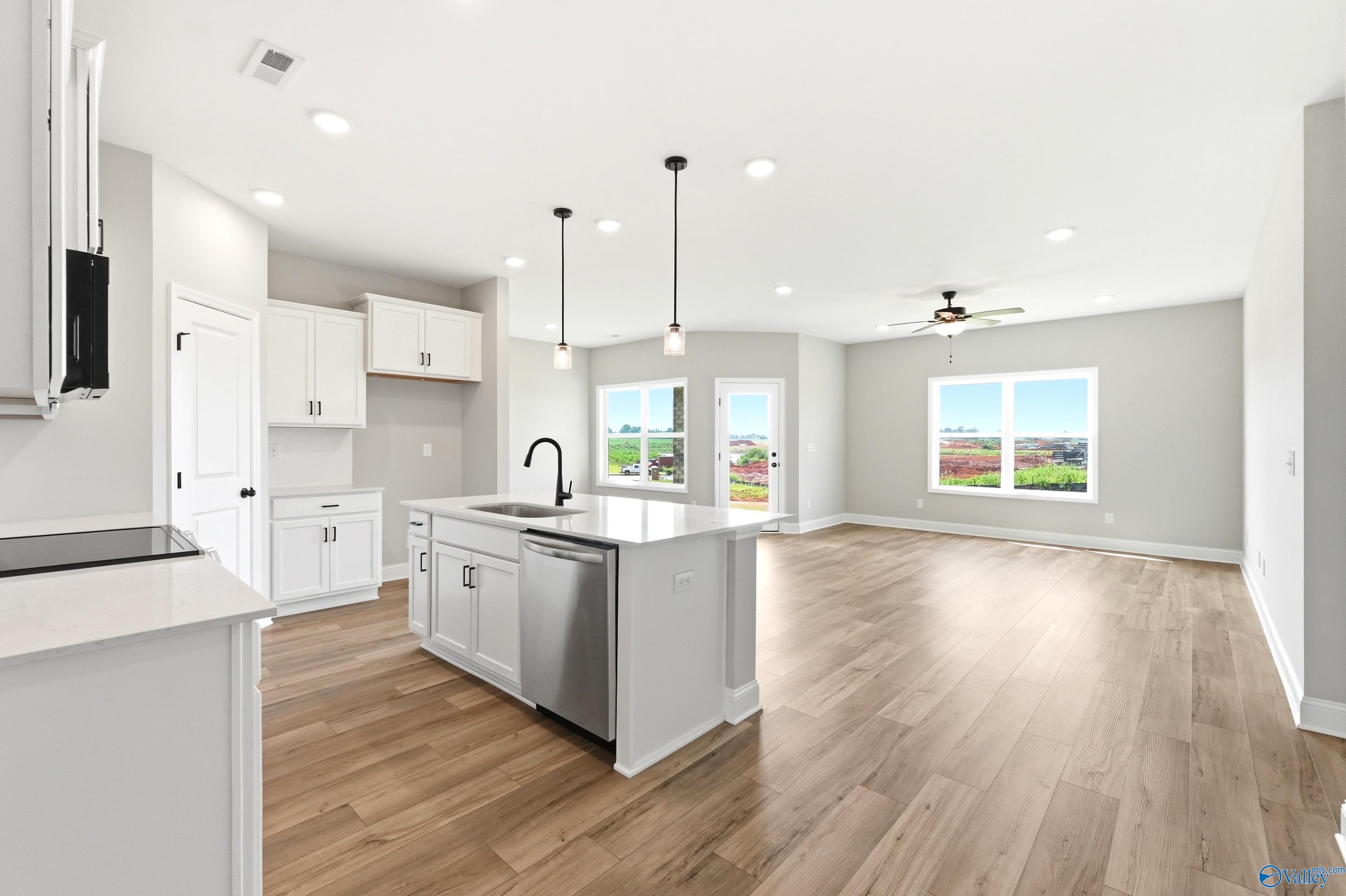 Open-concept kitchen and living area in The Daphne D floor plan by Davidson Homes in Creekside, Harvest, Alabama.