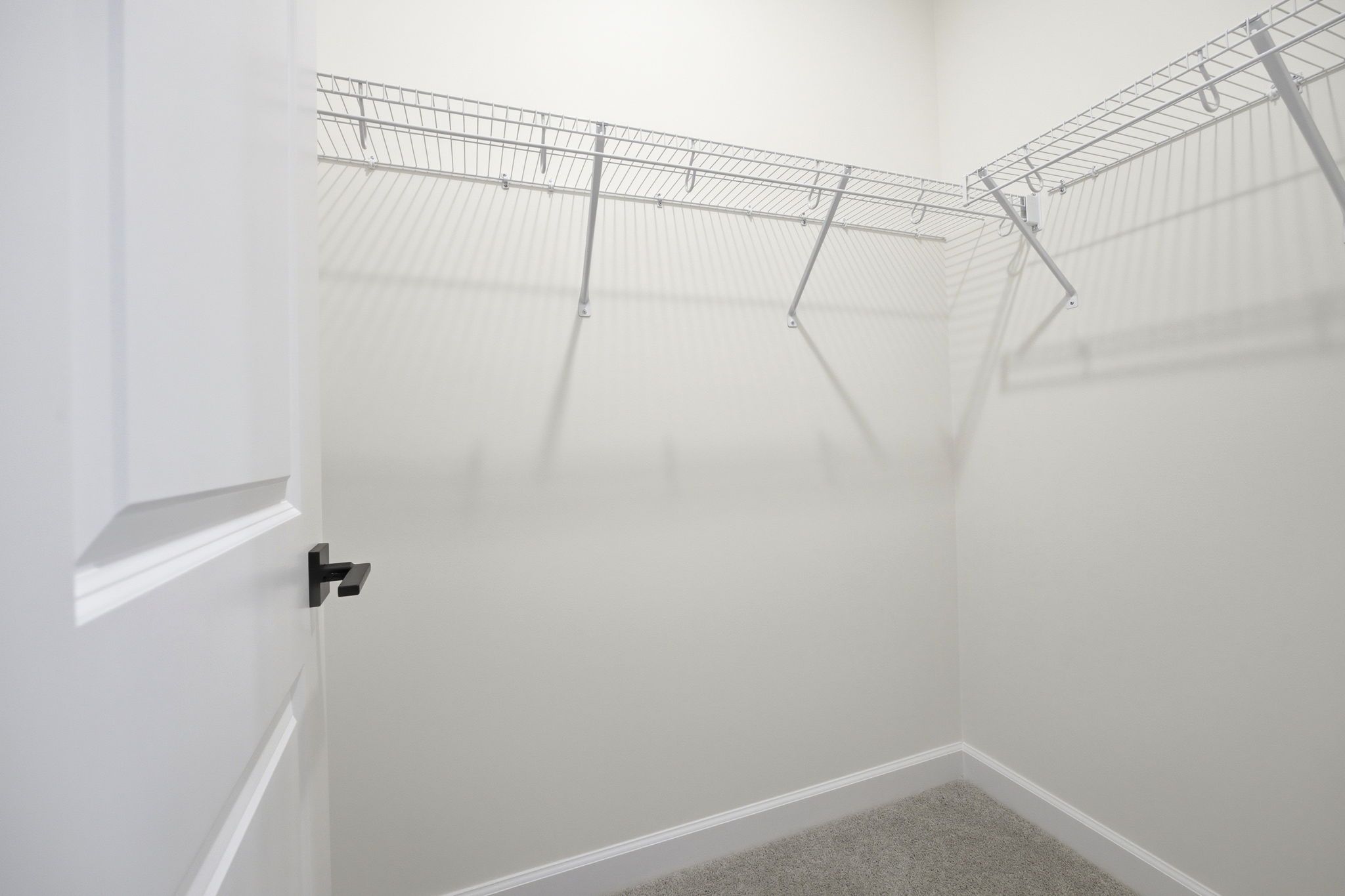 Spacious walk-in closet with wire shelving in The Ashport master suite by Davidson Homes.