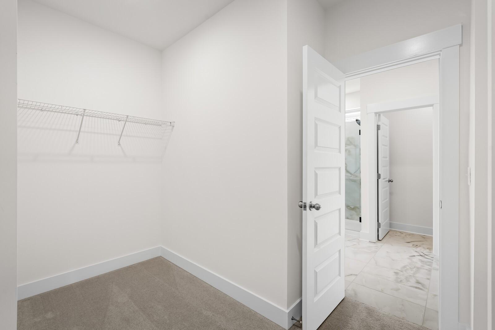 Walk-in closet connected to master bathroom in The Prairie C floor plan at Woods Crossing, Gallatin, Tennessee.