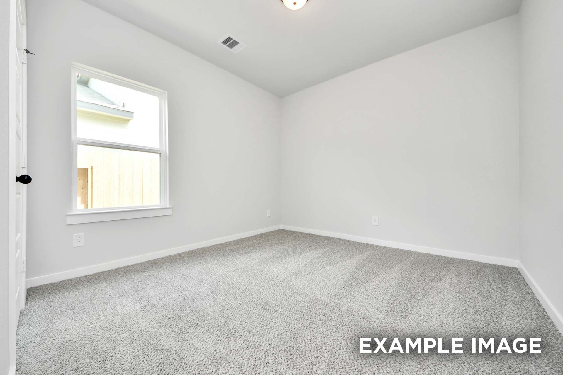 Bright and spacious secondary bedroom in The Sorrento floor plan featuring neutral paint and plush carpeting.