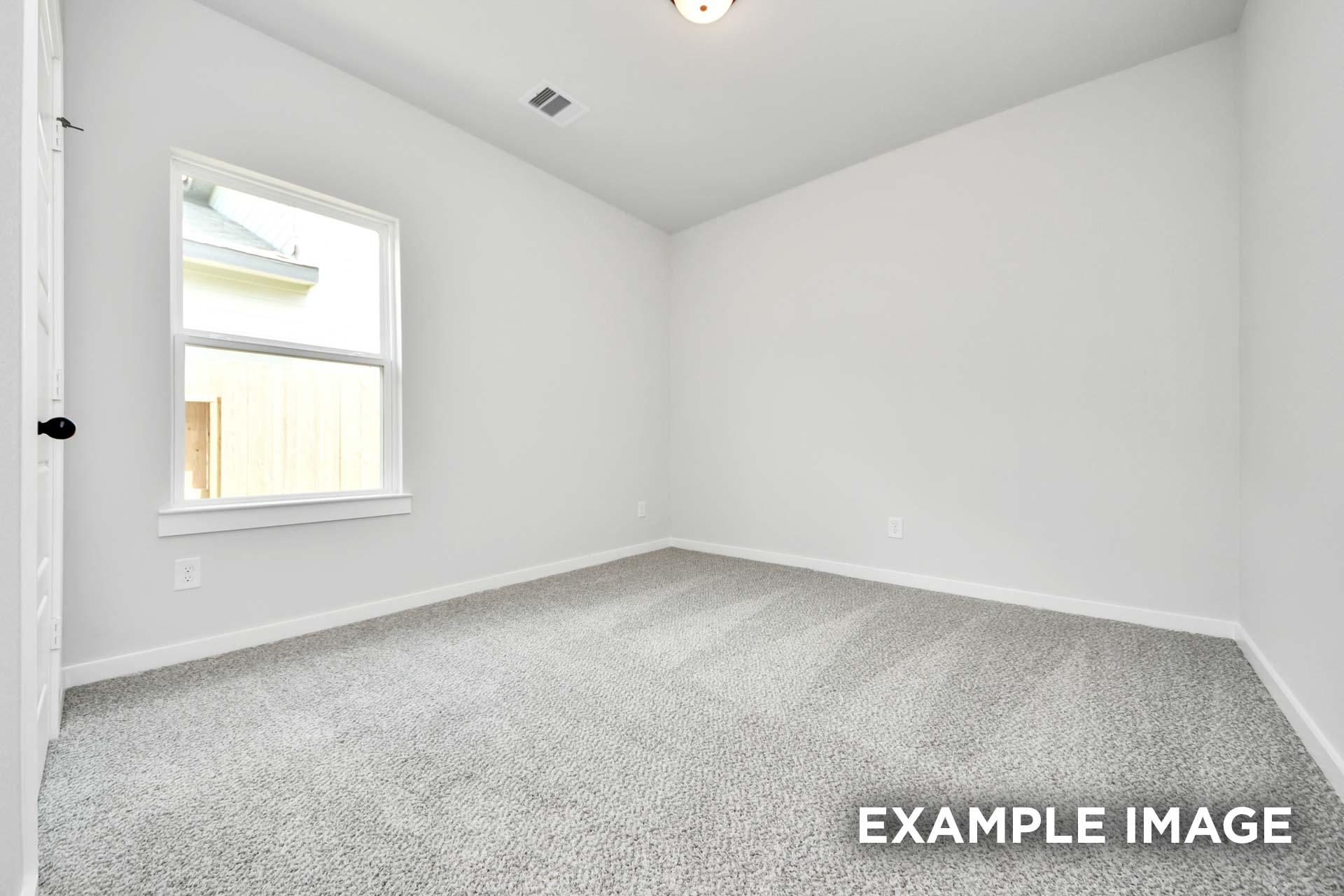 Bright and spacious secondary bedroom in The Sorrento floor plan featuring neutral paint and plush carpeting.