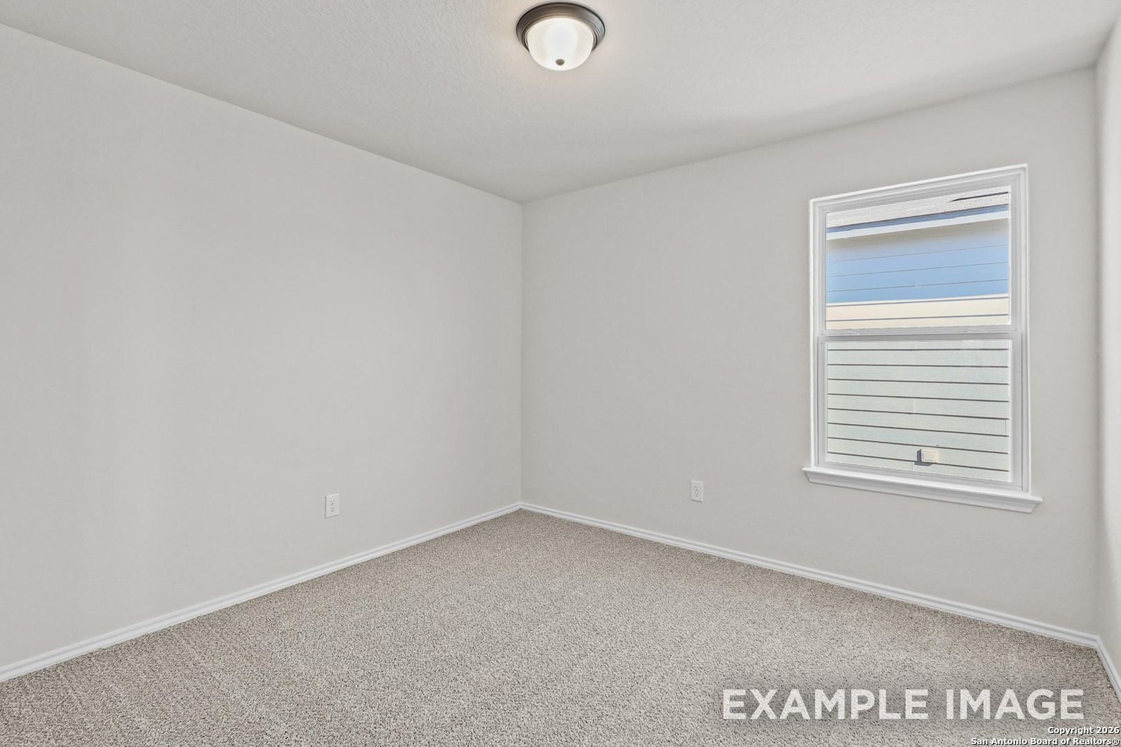 Bright empty bedroom with neutral walls, beige carpet, ceiling light, and window blinds in Davidson Homes The Trinity B, San Antonio TX