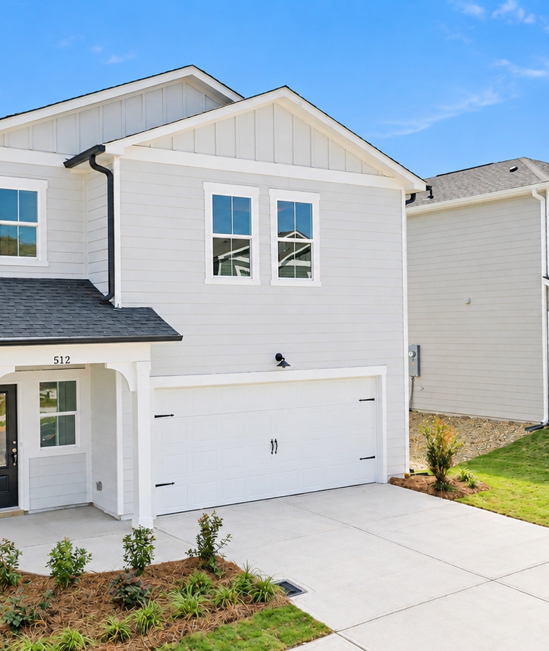 New construction homes by Davidson Homes at The Bluffs in Canton, Georgia featuring modern siding and two-car garages.