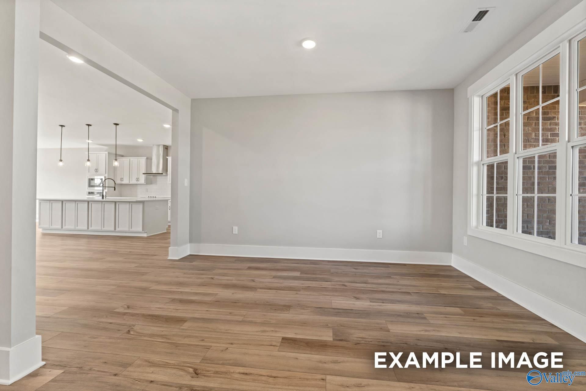 Open-concept living space with luxury vinyl plank flooring in The Finleigh by Davidson Homes, Briercreek, Meridianville.