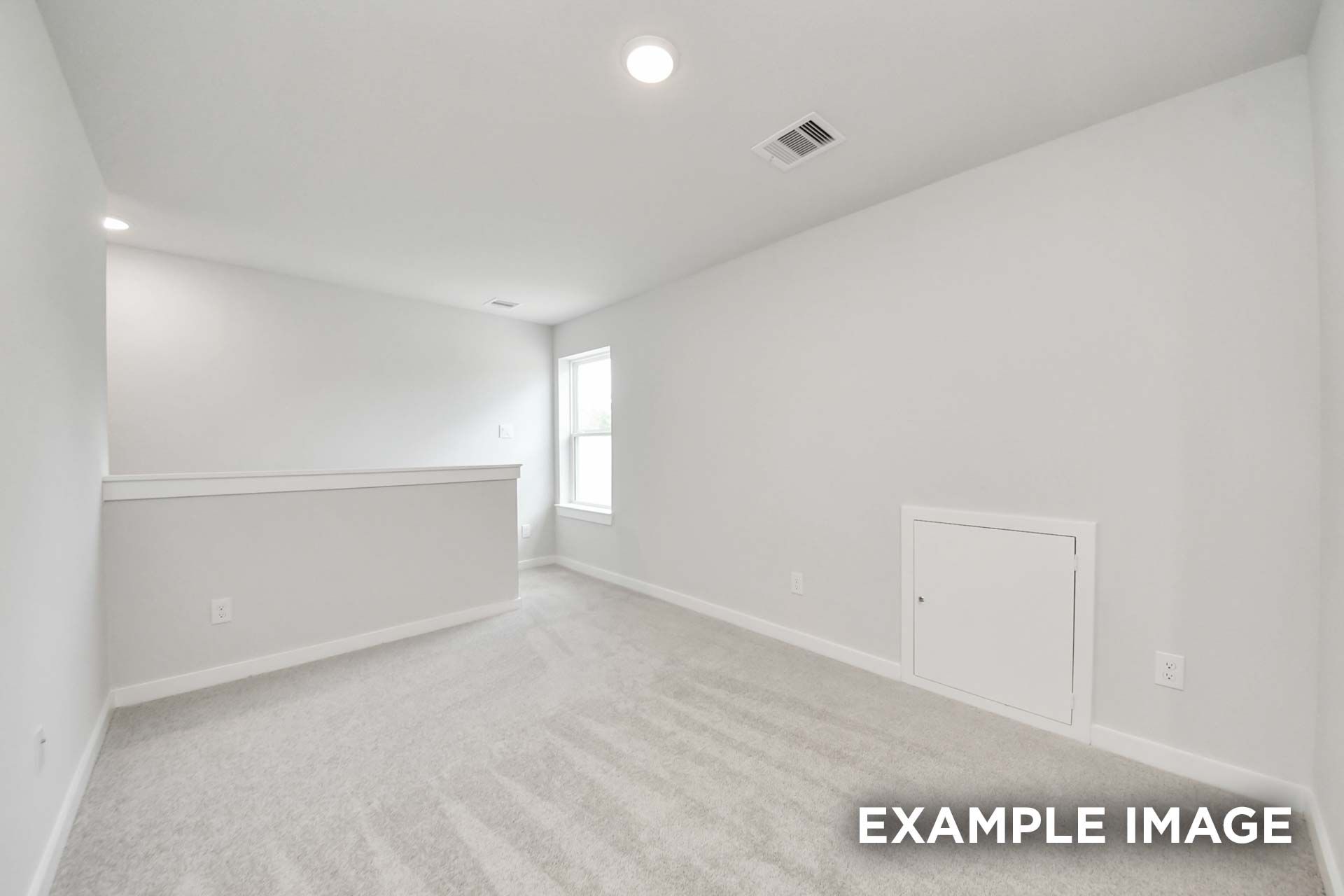 Spacious upstairs bedroom in The Blanco by Davidson Homes with neutral carpet, white walls, and half-wall overlooking loft