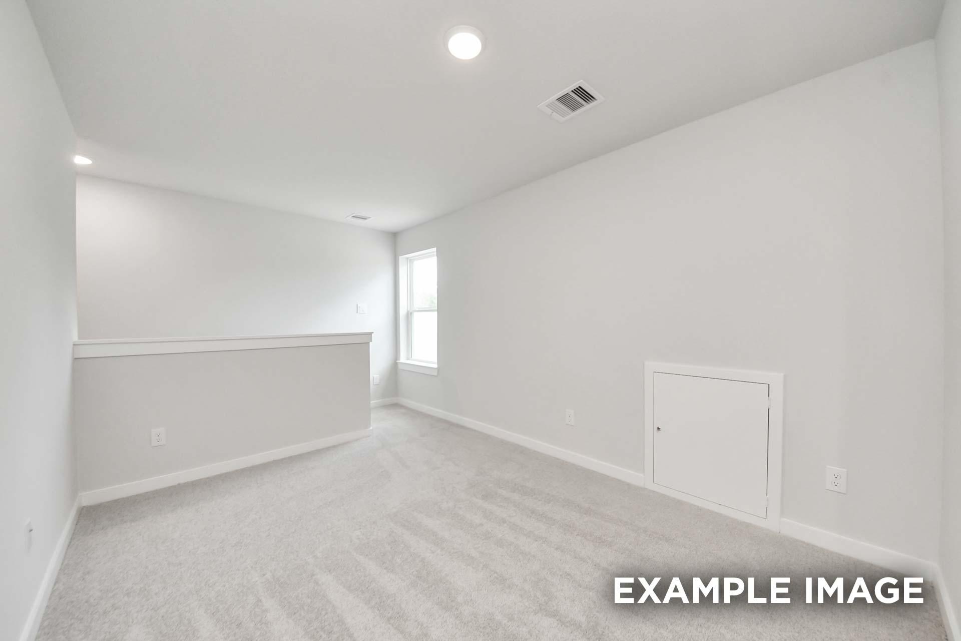 Spacious upstairs bedroom in The Blanco by Davidson Homes with neutral carpet, white walls, and half-wall overlooking loft