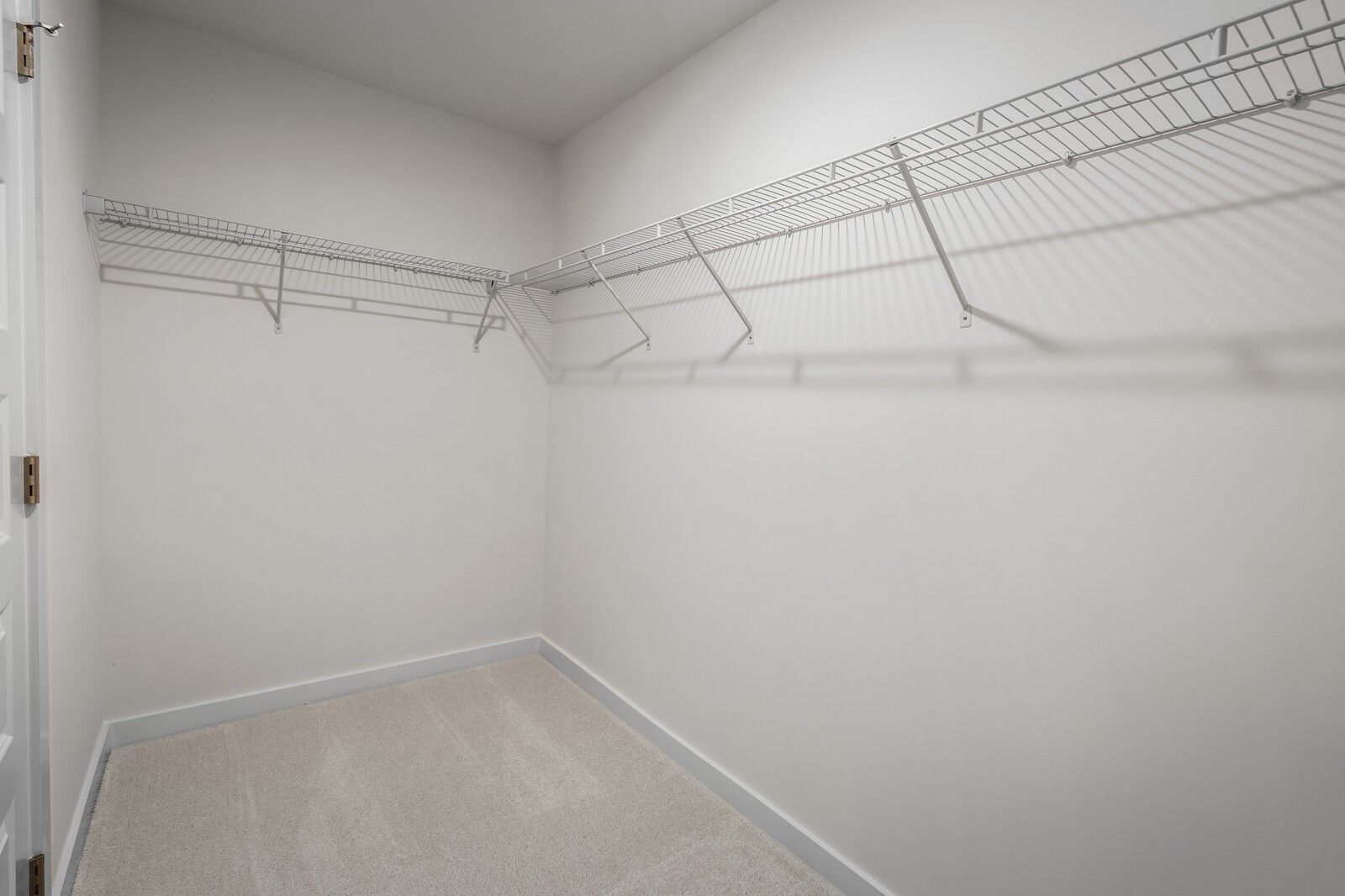 Spacious walk-in closet with wire shelving in The Willow floor plan at Woods Crossing, Gallatin, Tennessee.