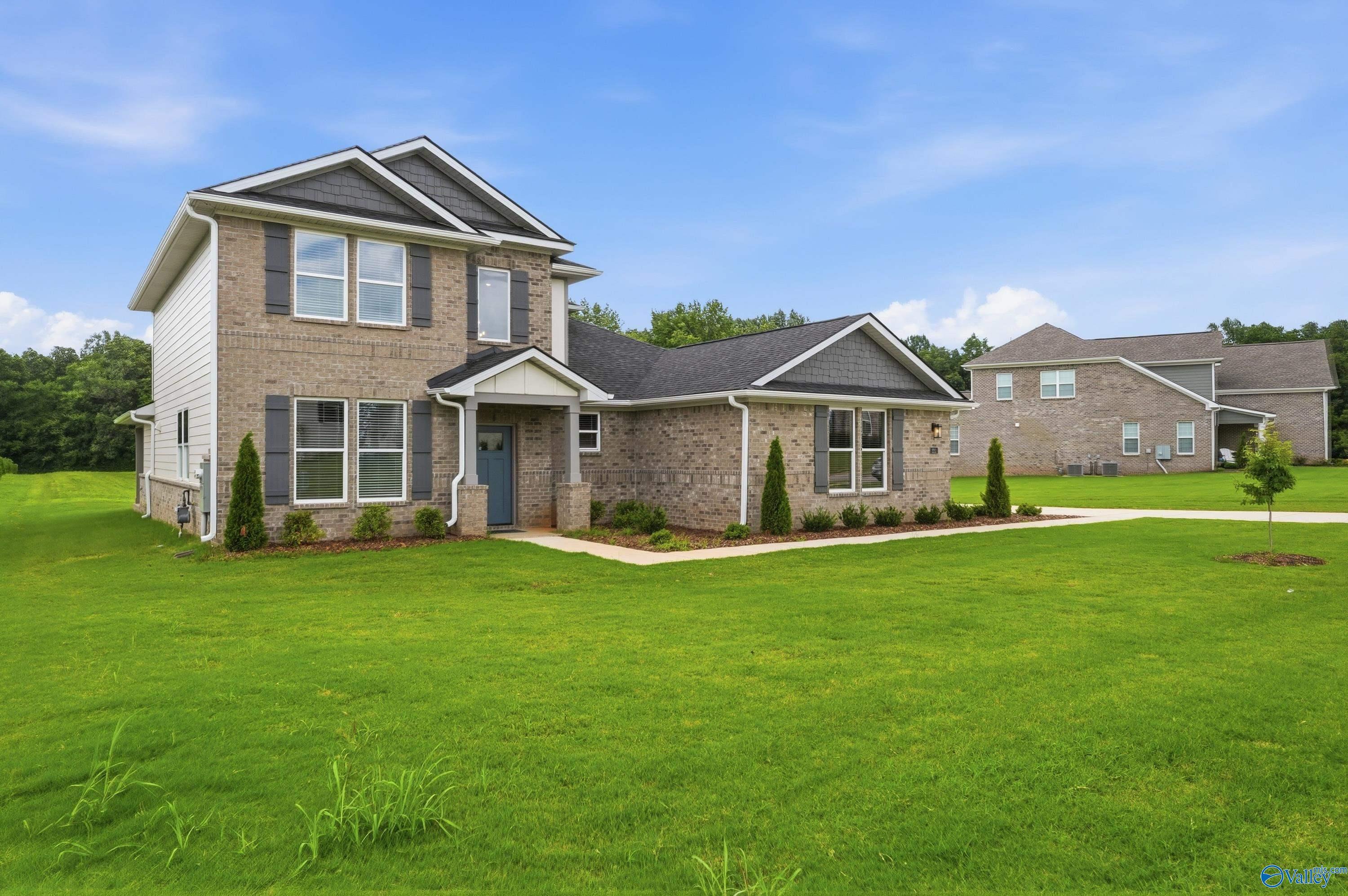 Two-story brick exterior of The Dorado floor plan by Davidson Homes in Riverton Preserve, Huntsville, Alabama.