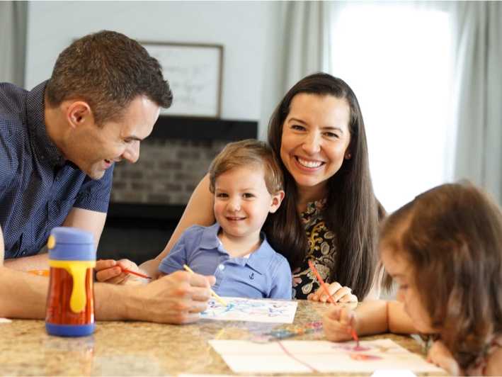 Davidson Homes homeowners sitting in a kitchen as a family.
