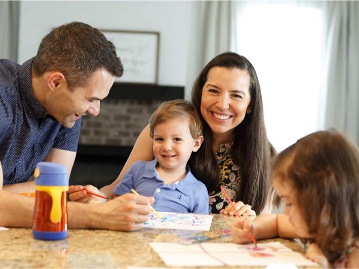 Davidson Homes homeowners sitting in a kitchen as a family.